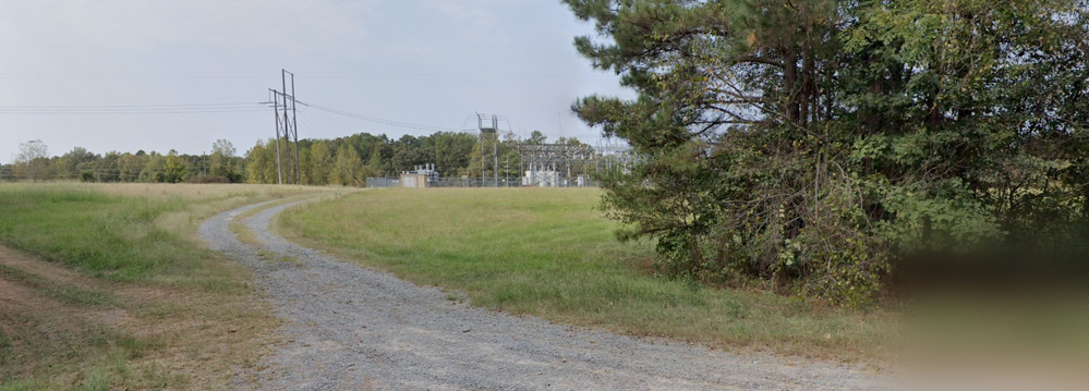 2-View of driveway leading to the facility as seen from Highway.